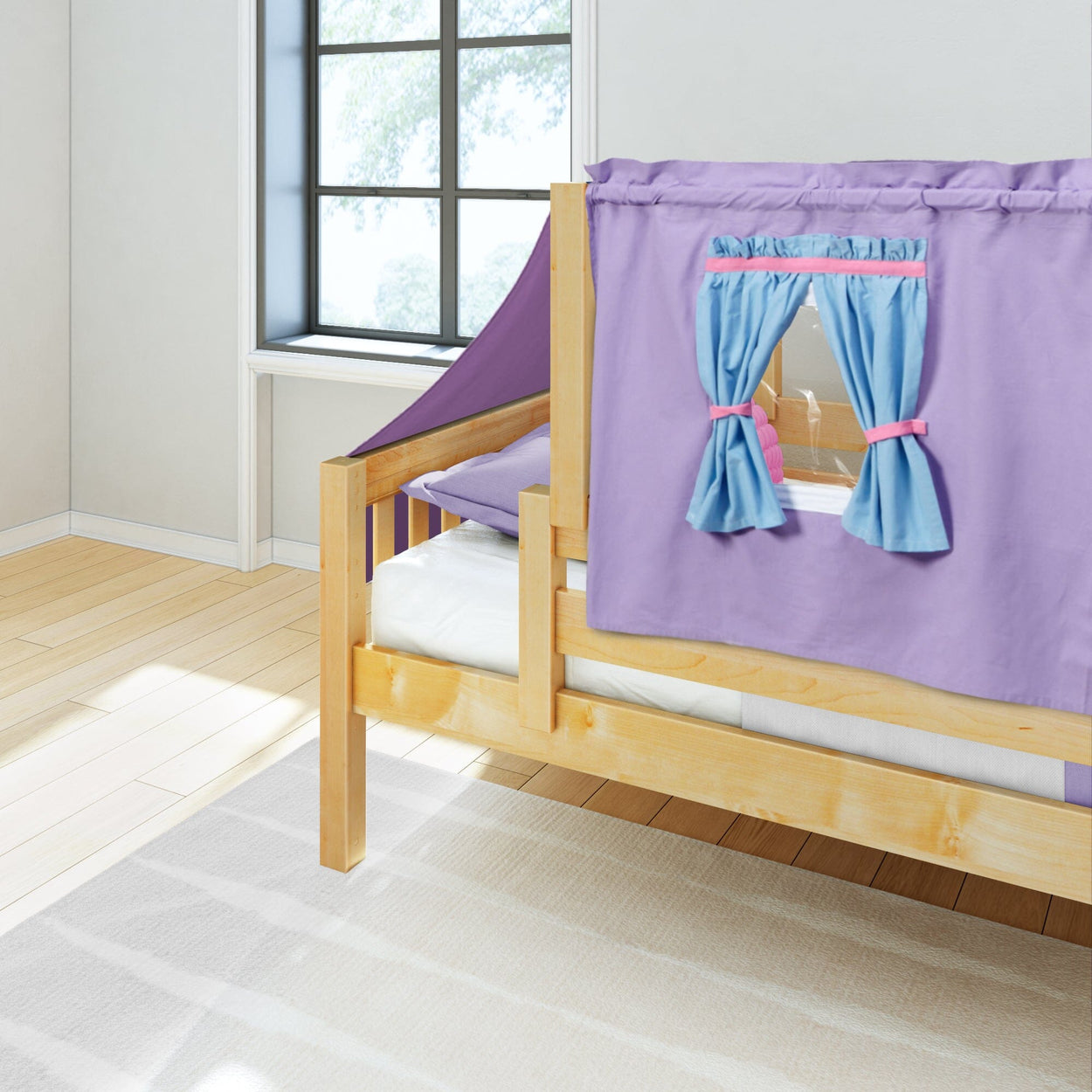 Wooden loft bed with purple tent cover and blue curtains in bright, modern bedroom.