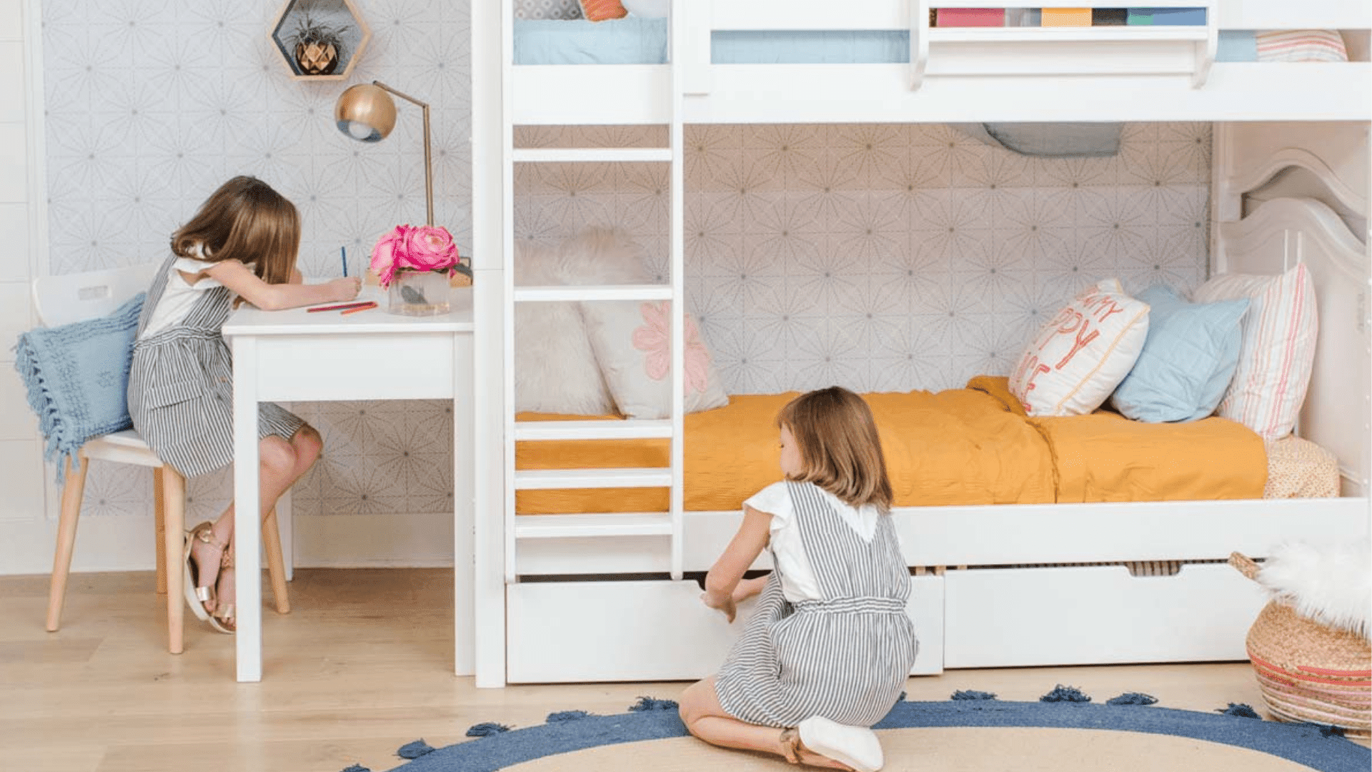 Twin over twin bunk bed with desk in girls room with colorful decor