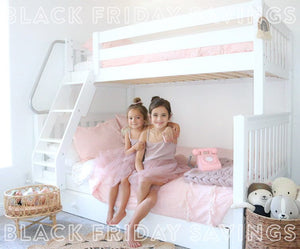 Solid hardwood twin over full bunk bed with angled ladder in girls shared room