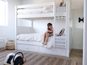 White bunk bed with underbed storage in neutral boys bedroom