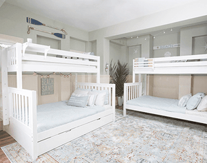 White bunk beds in vacation rental beach house with neutral decor