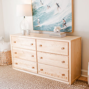 Natural birch 6 drawer dresser in a beach themed room.