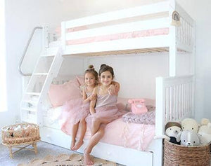 White twin over full bunk bed with angled ladder in shared girls room