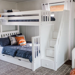 White bunk bed with staircase with blue bedding.