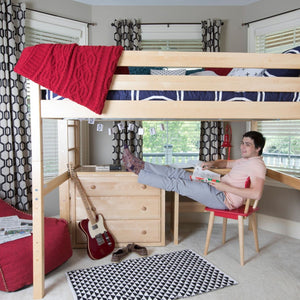 Natural queen loft bed with red and blue bedding and a young boy beneath it reading with his guitar.