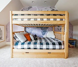 White queen over queen bunk bed with blue bedding in a white room.