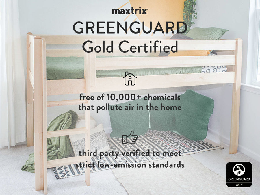 A natural finish loft bed with green bedding with a text overlay on it reading "Maxtrix Greenguard Gold Certified". Below that, an icon of a house with the text "free of 10,000+ chemicals that pollute air in the home". Below that a thumbs up icon with the text "third party verified to meet strict low-emission standards". At the bottom right of the image, there is a Greenguard Gold black and white logo.