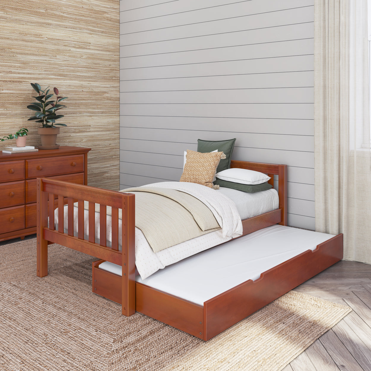 Single wooden bed with trundle and cozy bedding in a modern bedroom setting.