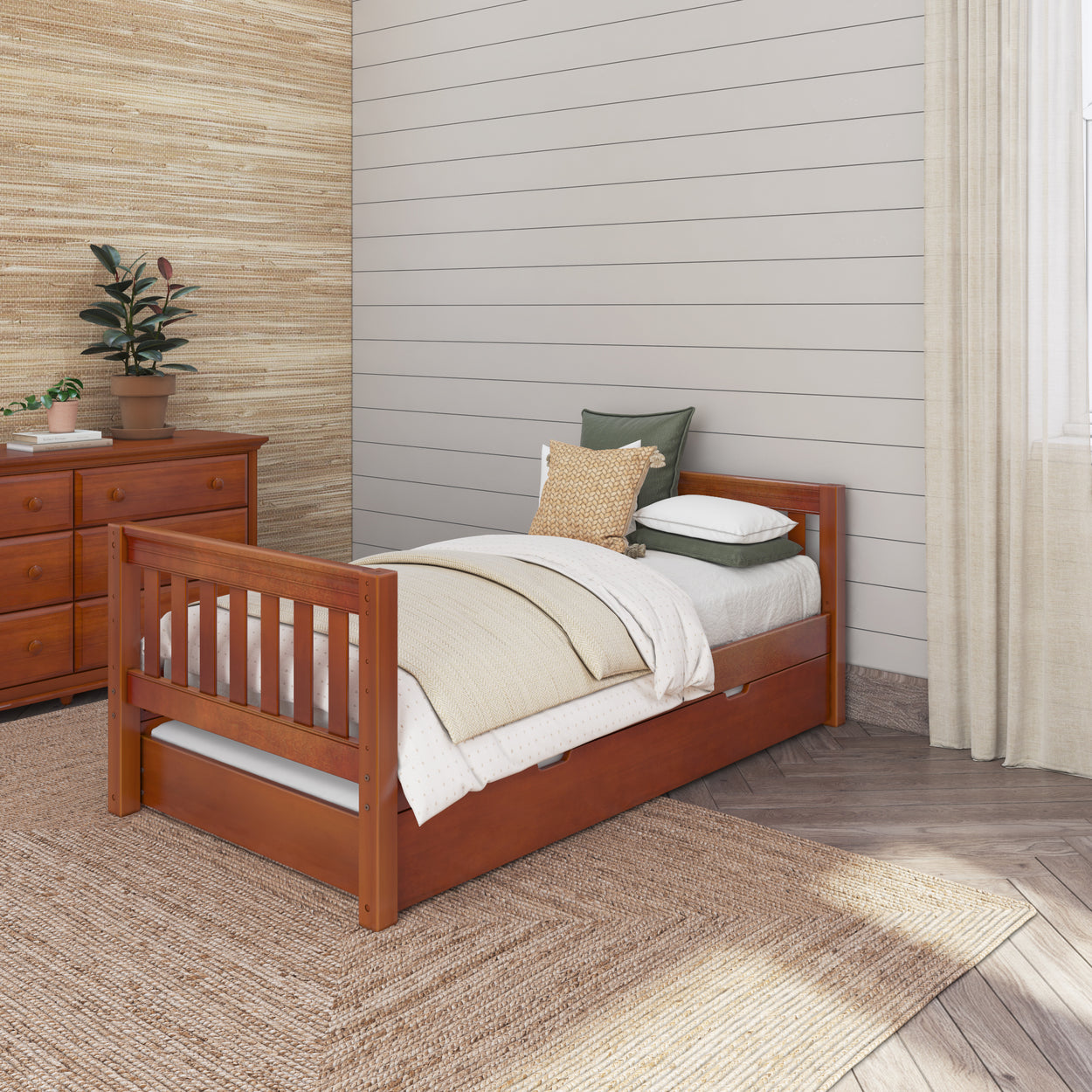 Wooden twin bed in cozy bedroom with dresser and plants.