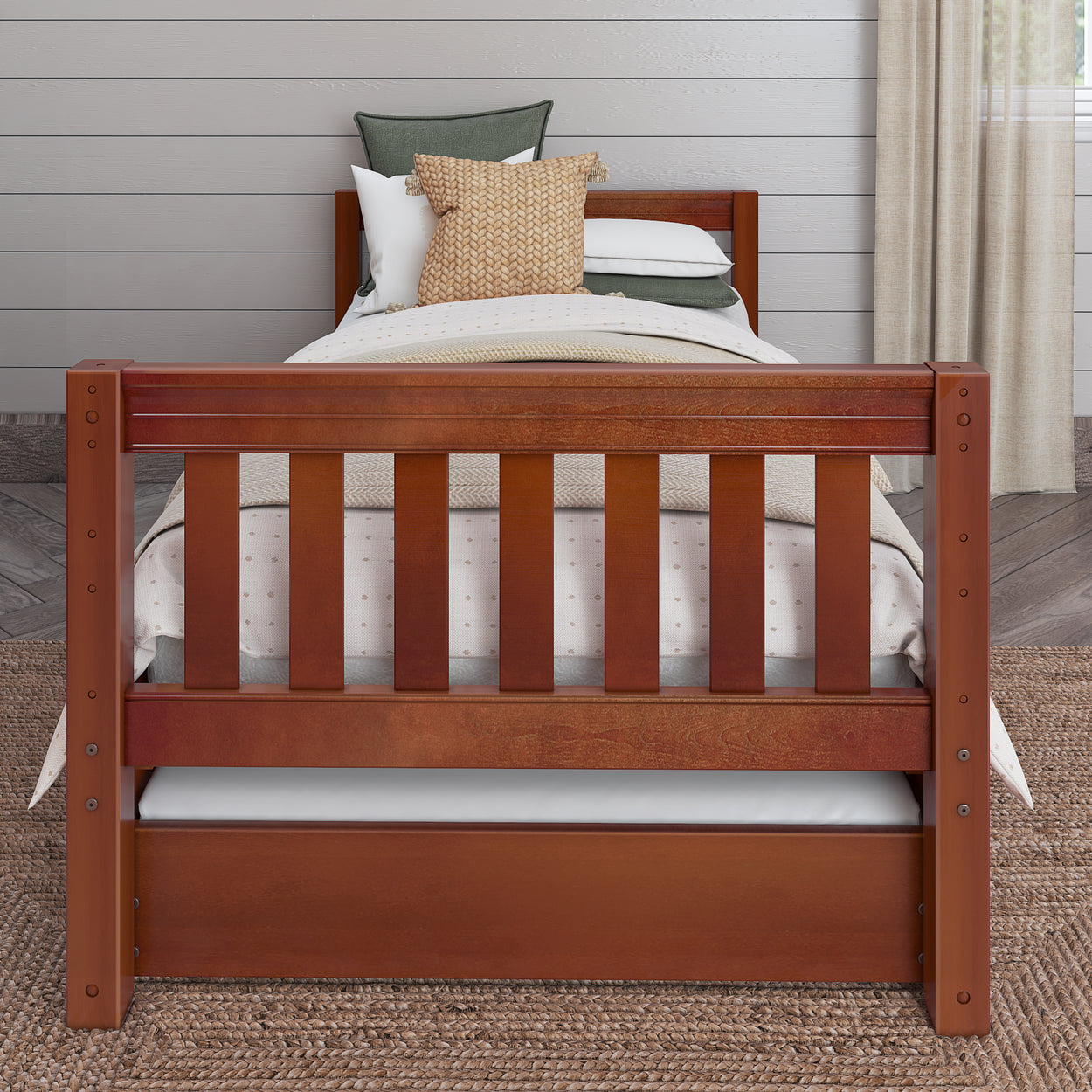 Wooden twin bed with woven rug and cozy bedding in a stylish bedroom.