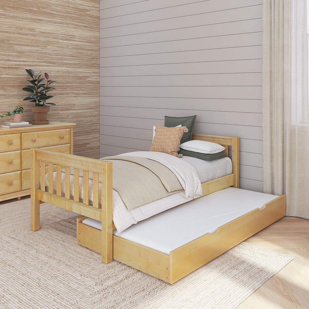 Natural wood twin bed with pull-out trundle in a cozy bedroom setting.