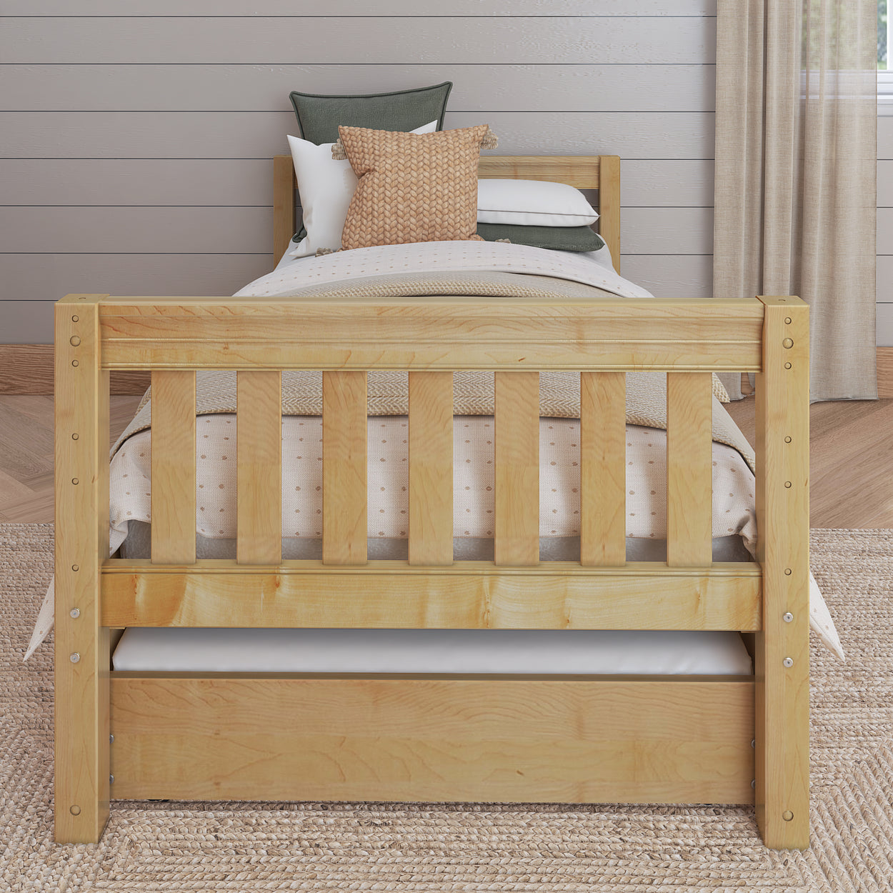 Wooden twin bed with trundle storage in a cozy bedroom setting.