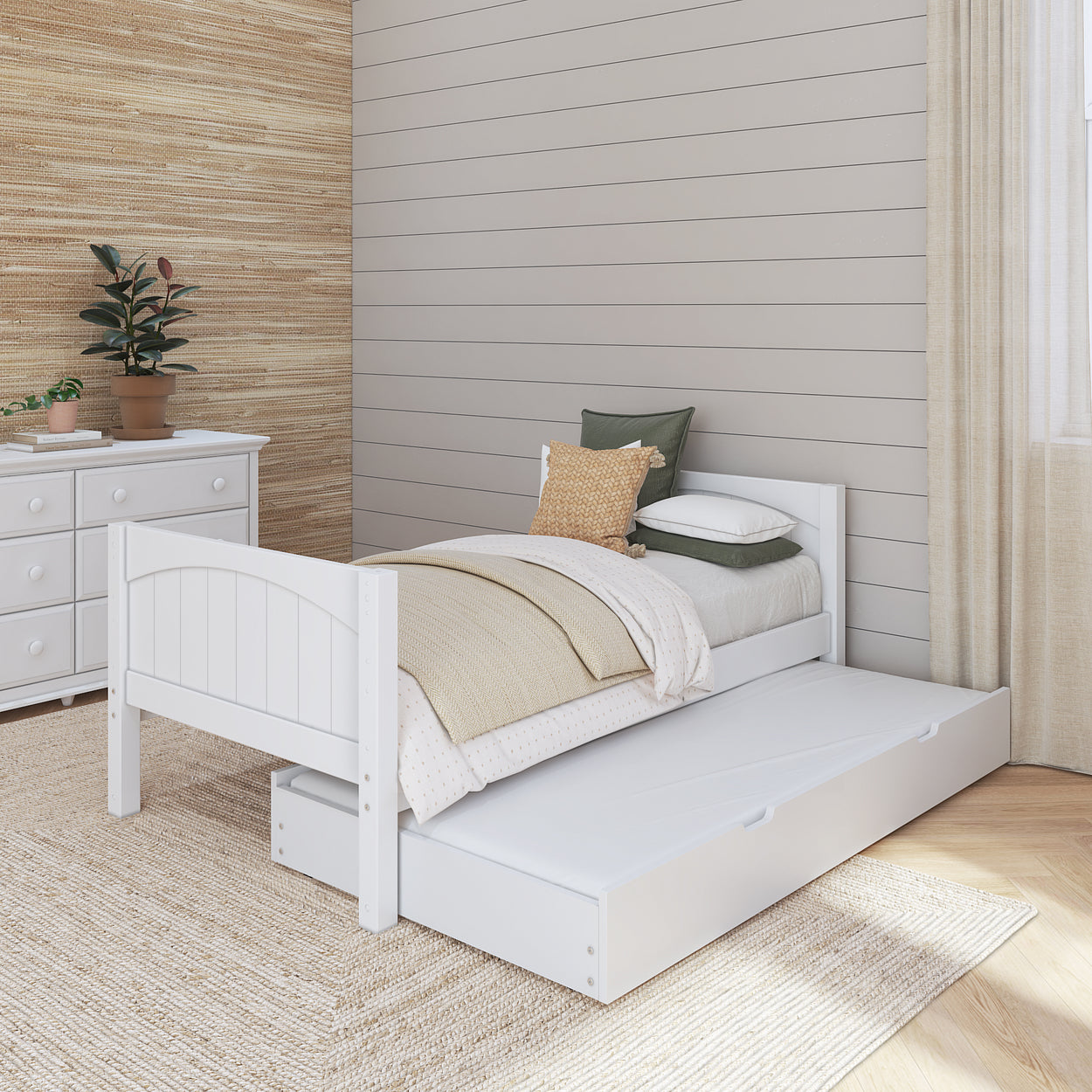 White twin bed with pull-out trundle in a cozy bedroom with beige walls and natural decor.