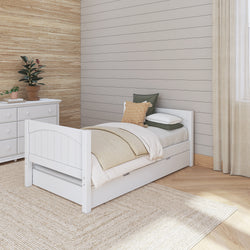 Cozy bedroom with white wooden bed frame and beige bedding set, featuring a potted plant and dresser against shiplap wall, ideal for modern home decor inspiration.