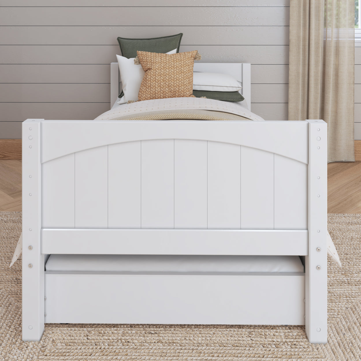 White wooden twin bed with pillows in modern bedroom setting.
