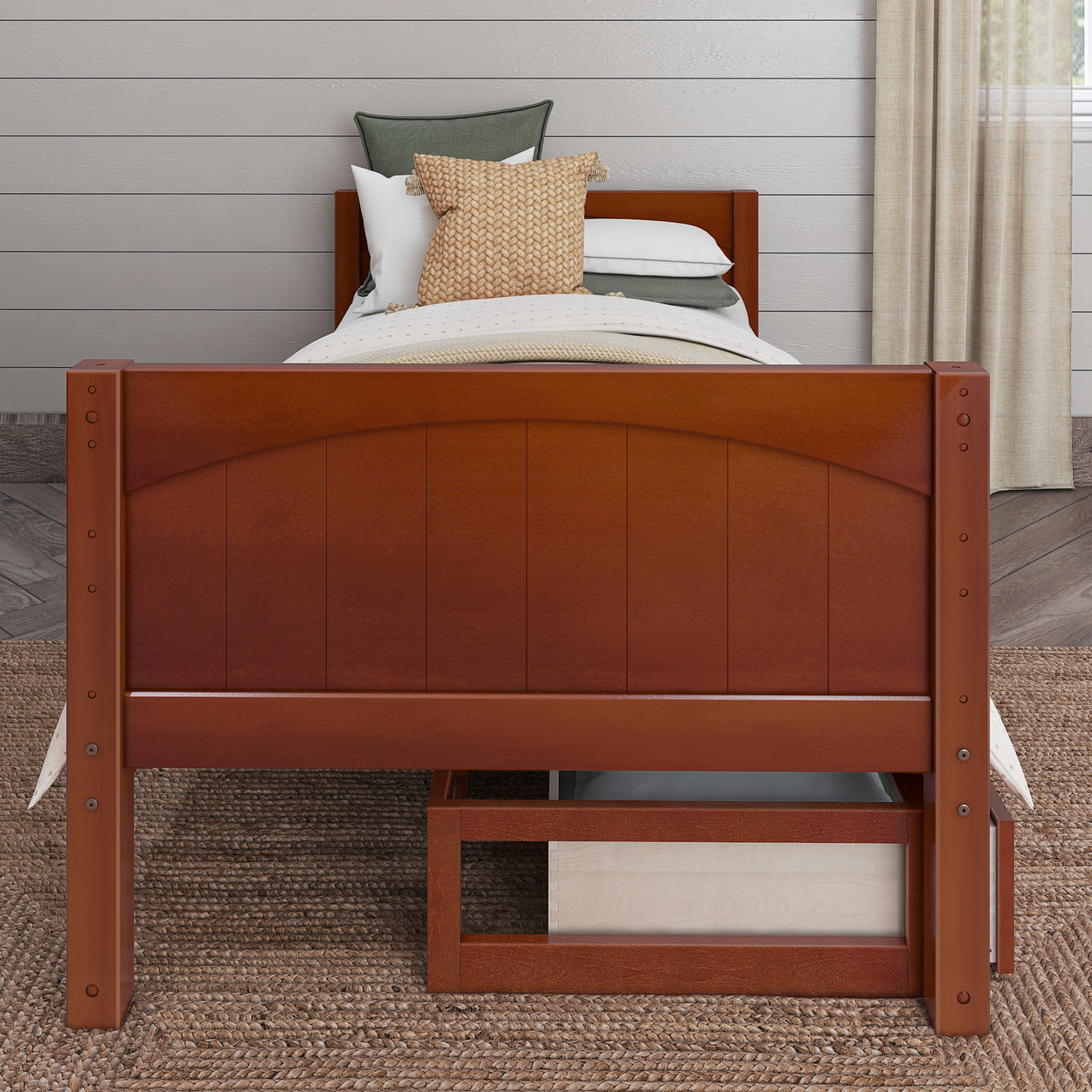 Wooden bed with decorative pillows and neutral bedding in a cozy bedroom.