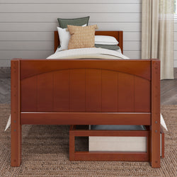 Wooden bed with decorative pillows and neutral bedding in a cozy bedroom.