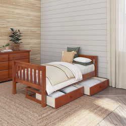 Wooden twin bed with storage drawers and cozy pillows in a modern bedroom setting.