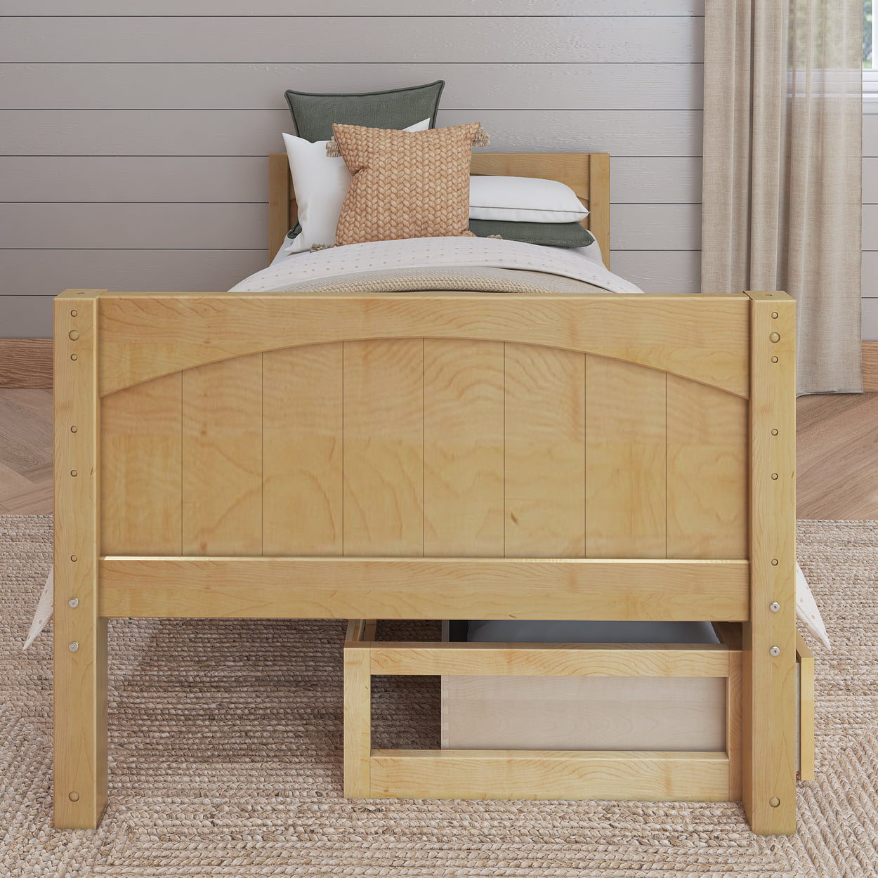 Wooden twin bed with storage drawer and cozy bedding in a modern bedroom.