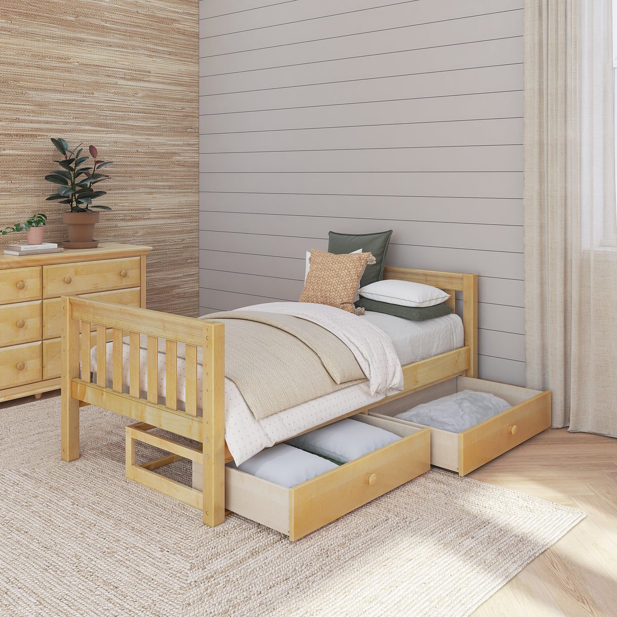 Wooden single bed with storage drawers in a modern bedroom setting, featuring a dresser and potted plant for cozy home decor.
