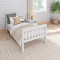 Cozy neutral bedroom with white farmhouse bed, beige bedding, nightstand with lamp, fiddle leaf fig in woven basket.