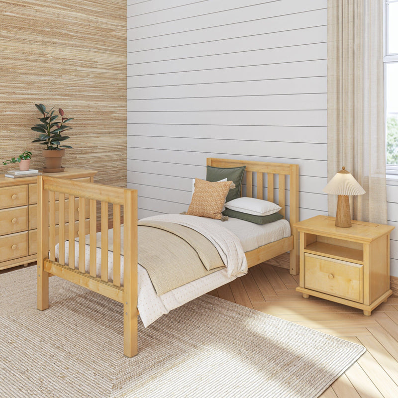 Minimalist neutral nursery with light wood crib and nightstand, beige shiplap accent wall, woven rug, potted plants and textured bedding