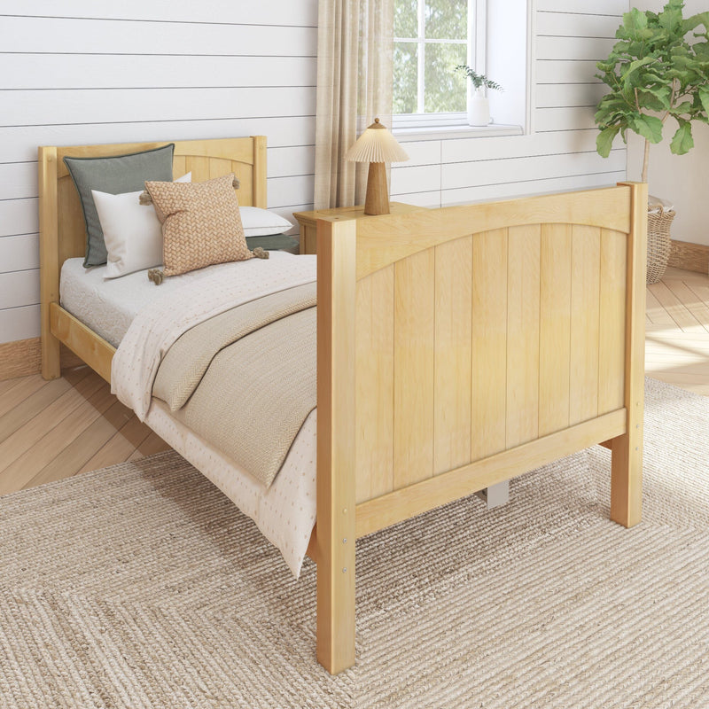 Cozy sunlit farmhouse bedroom with light wooden bed frame, neutral bedding and knit pillows, woven jute rug, shiplap wall, bedside lamp and potted fiddle leaf fig