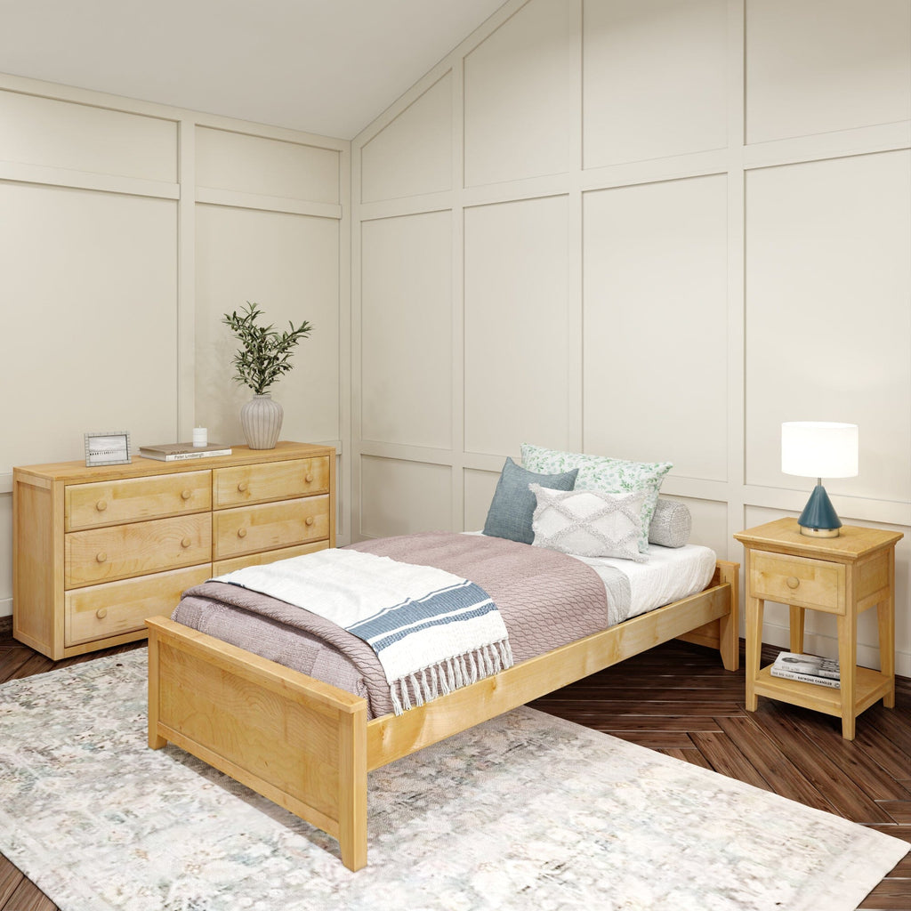 Cozy bedroom with wooden bed frame, decorative pillows, and bedside table in bright, modern interior.