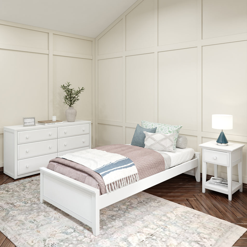 Cozy bedroom with white single bed, matching dresser and nightstand, featuring pastel bedding and elegant decor accents.