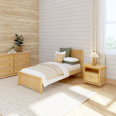 Cozy minimalist bedroom with wooden furniture, single bed, bedside table, dresser, and neutral decor.