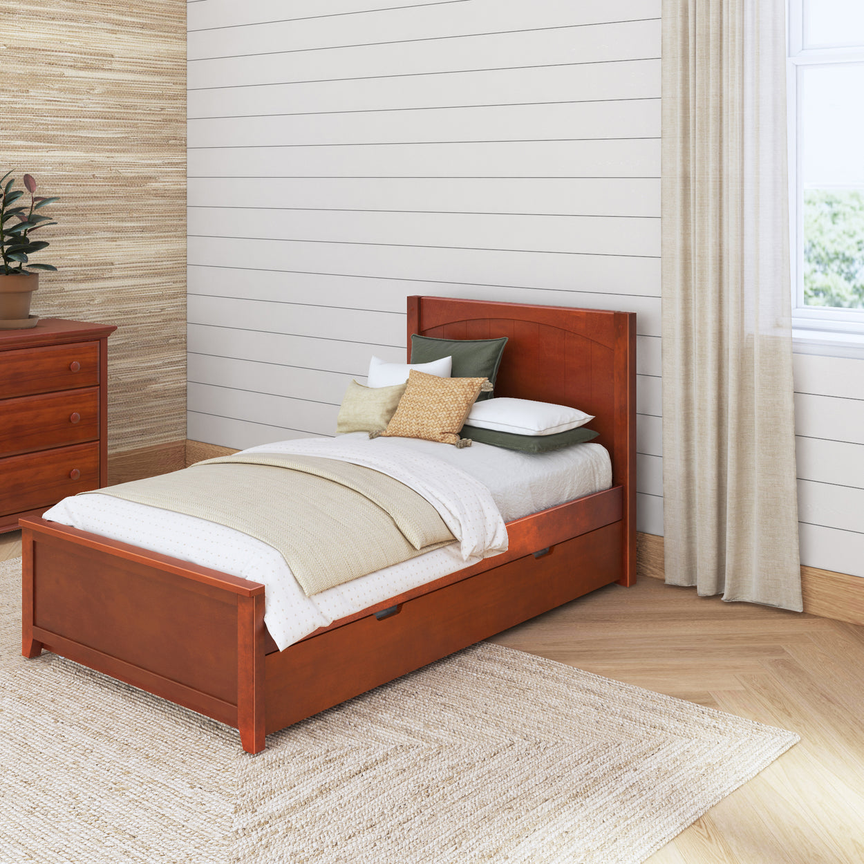 Single wooden bed with storage drawers in a cozy bedroom with neutral decor.