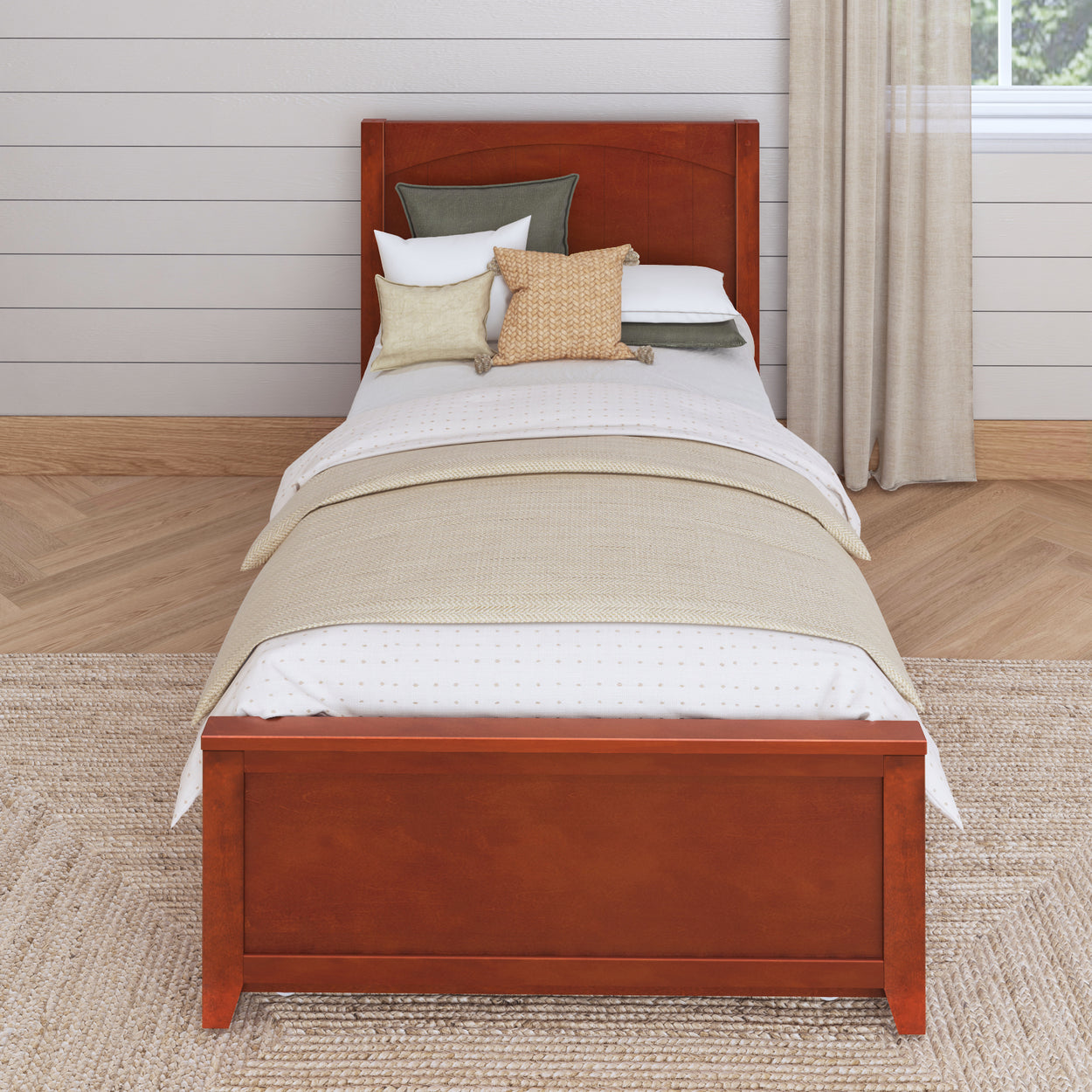 Wooden single bed with neutral bedding and decorative pillows in a modern bedroom setting.