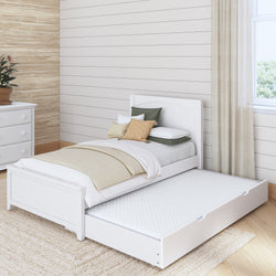 White twin bed with pull-out trundle in cozy bedroom with natural accents and light wood flooring.