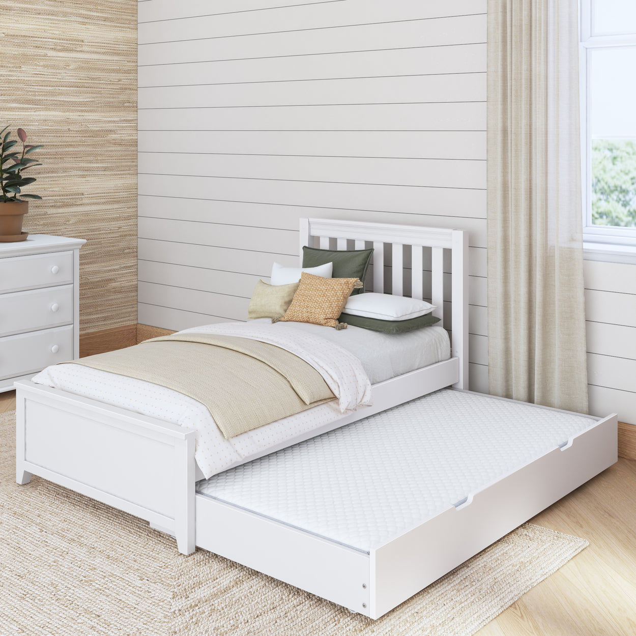 White wooden trundle bed with cozy bedding in a modern, minimalist bedroom setting.