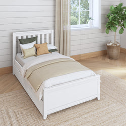 Single white bed in a modern bedroom setting with neutral decor and green plant.