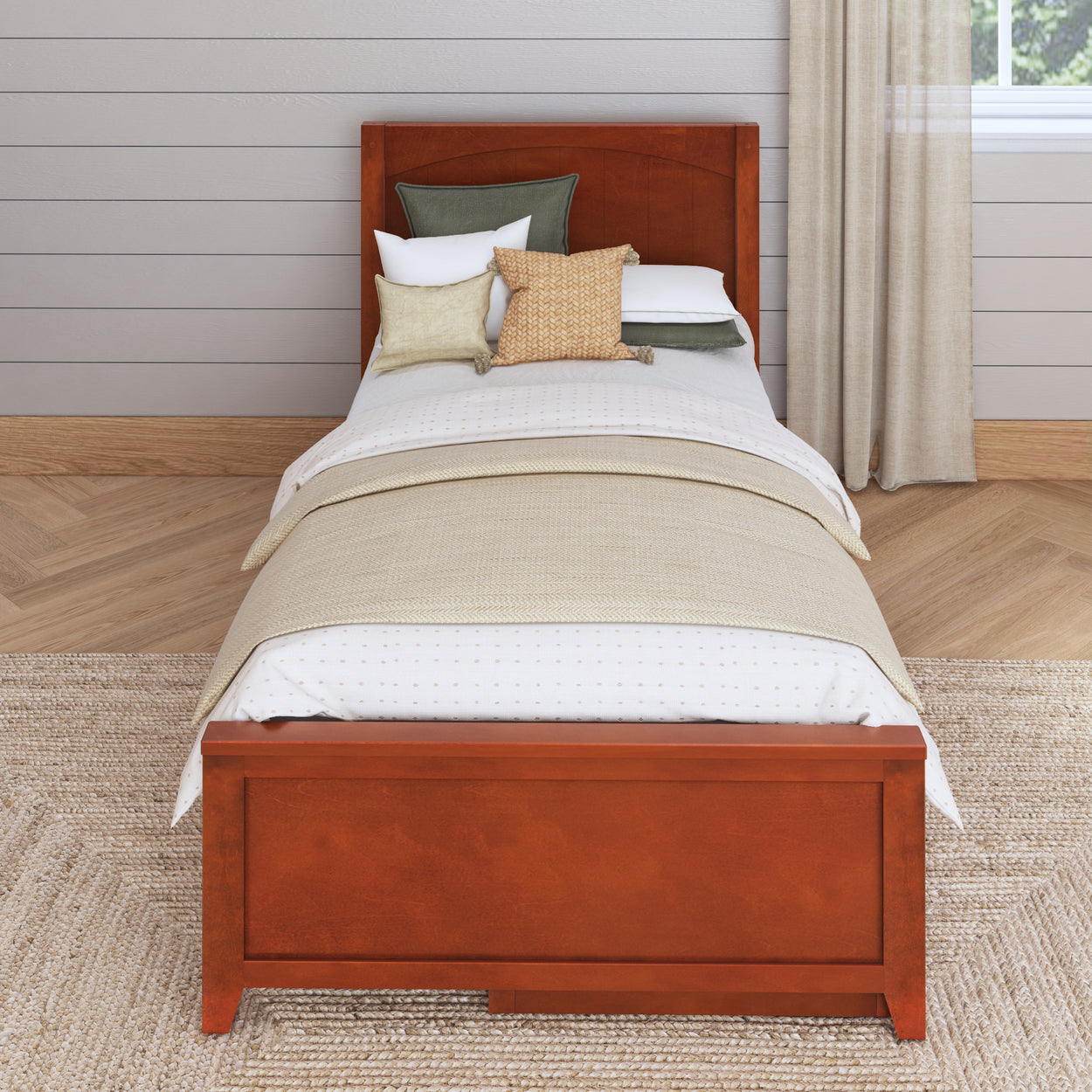 Single wooden bed with beige bedding and decorative pillows in a modern bedroom setting.