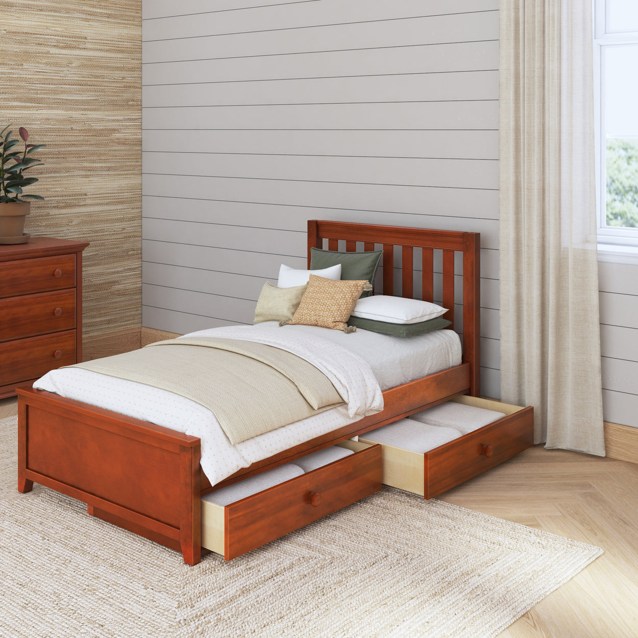 Wooden twin bed with storage drawers in a cozy bedroom setup.