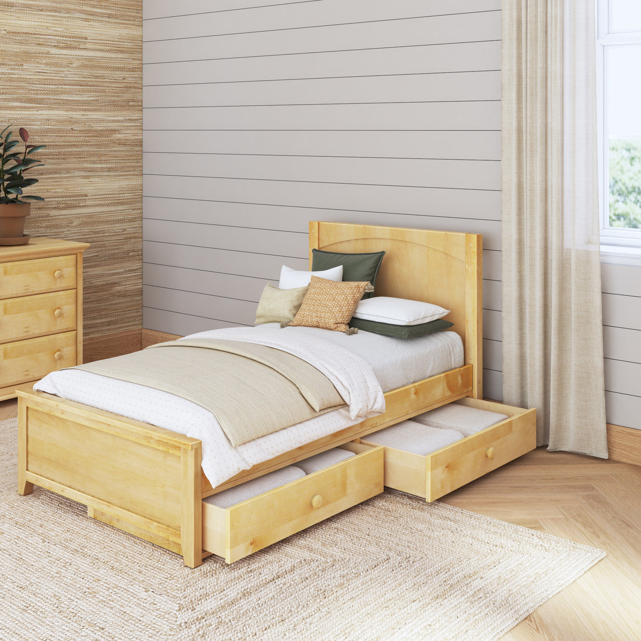 Wooden bed with storage drawers in a cozy, modern bedroom with natural decor and soft lighting.