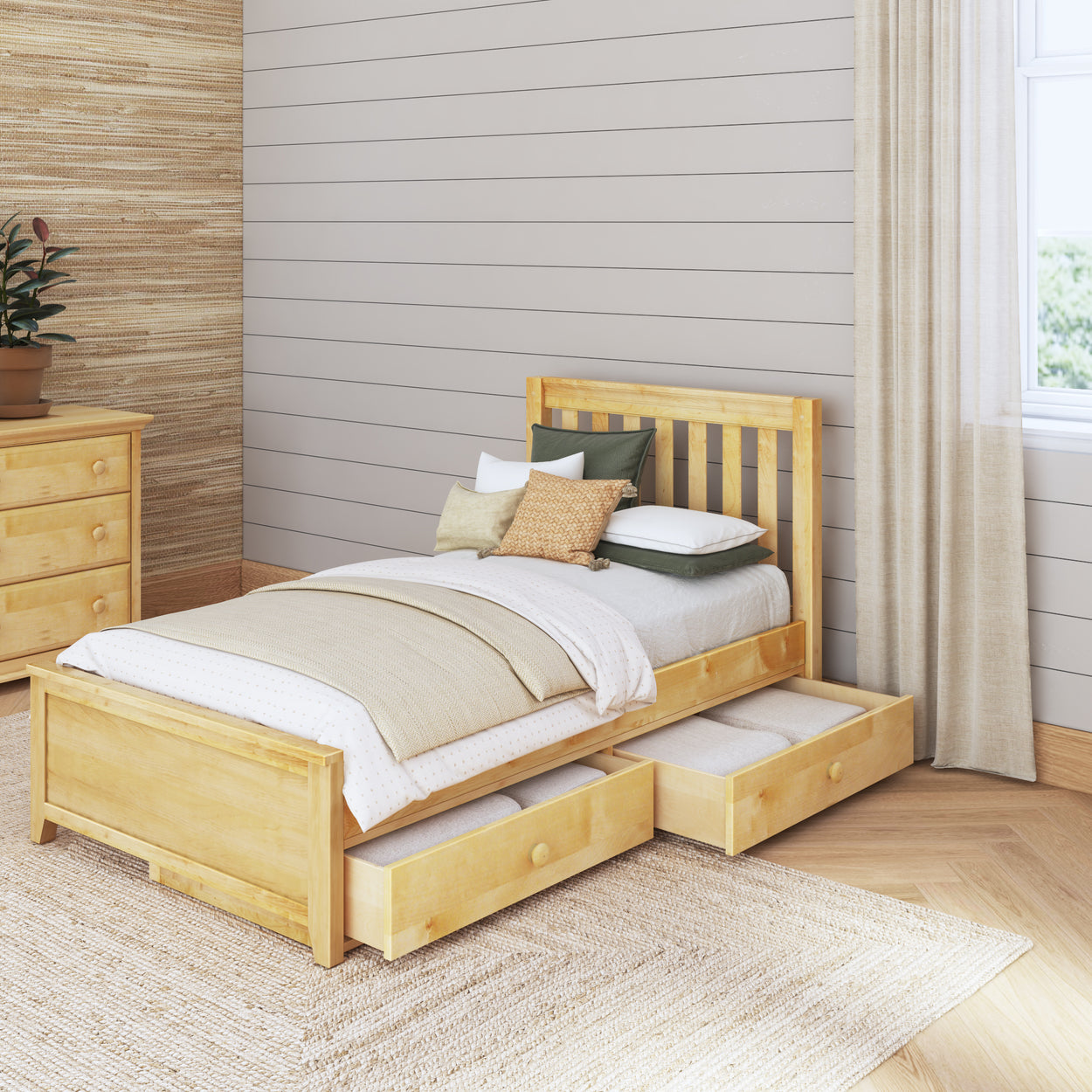 Single wooden bed with storage drawers in a cozy, modern bedroom.