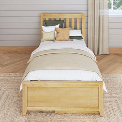 Stylish modern bedroom with wooden bed frame, layered bedding, and throw pillows in a cozy, neutral-toned setting.