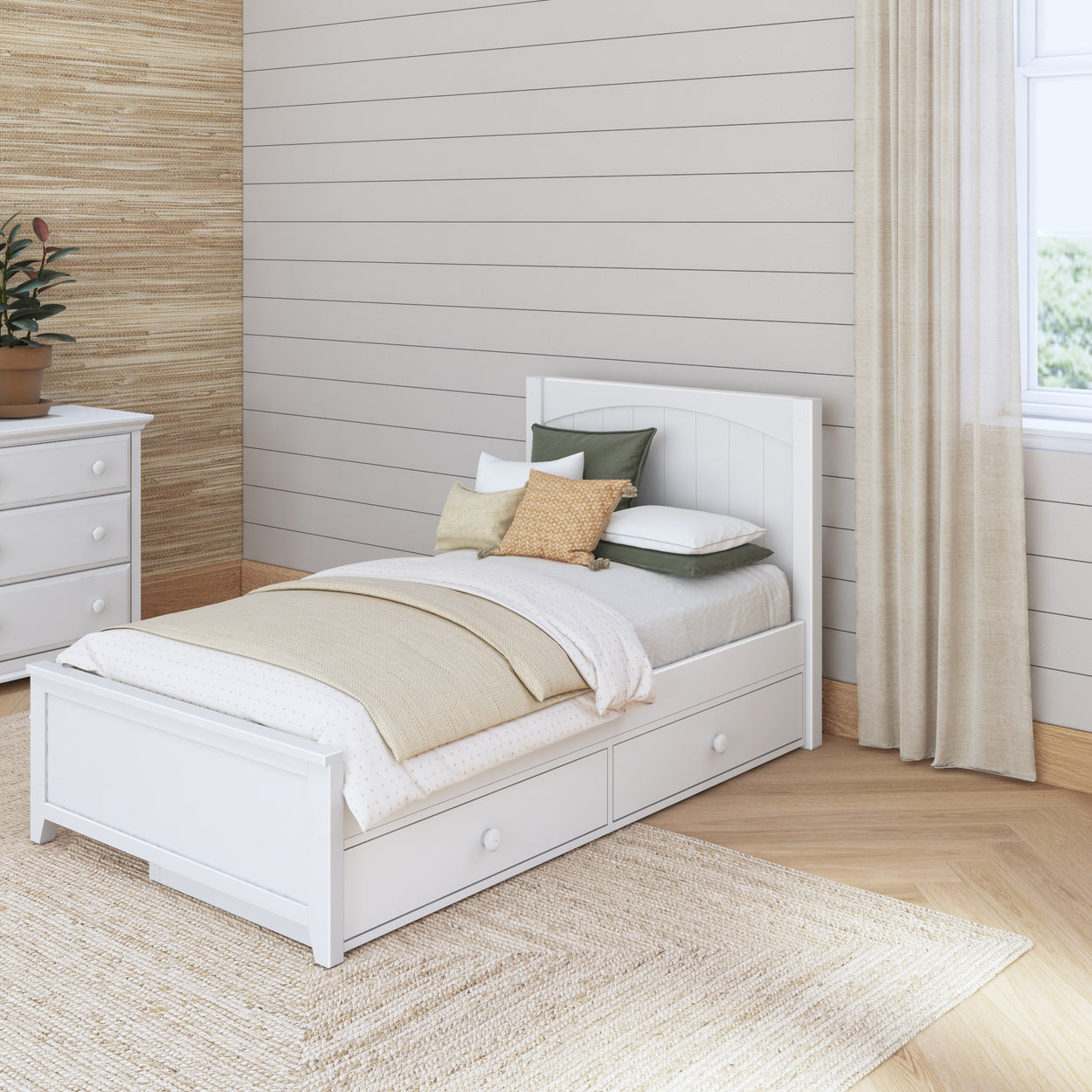 White wooden bed with storage drawers in cozy bedroom with natural decor elements.