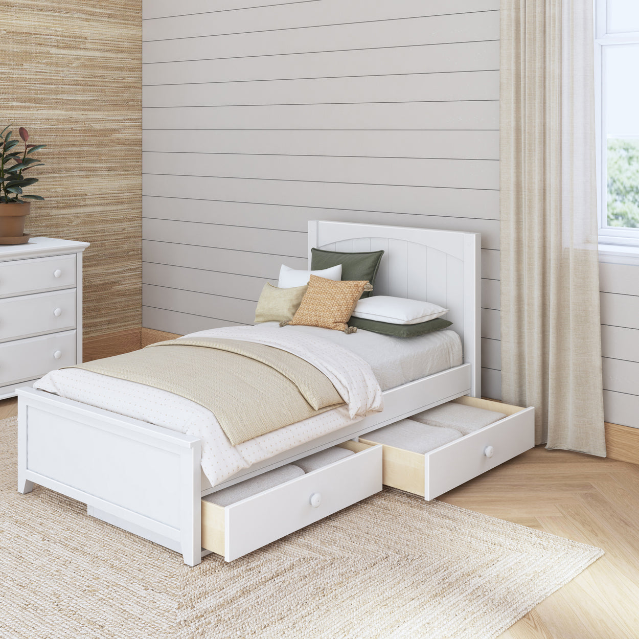 White wooden single bed with pull-out storage drawers in a cozy bedroom setting.