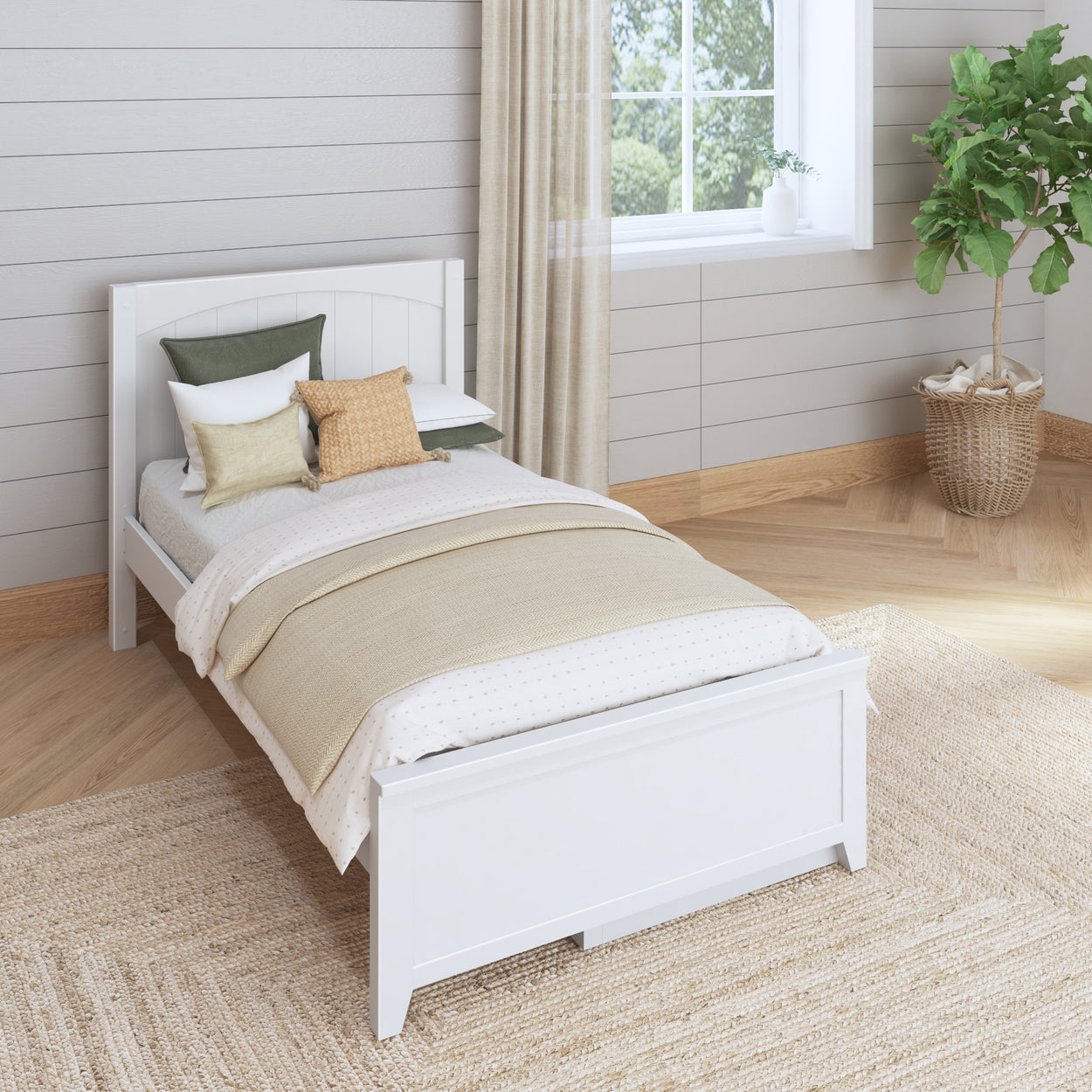 Modern minimalist bedroom with a white wooden single bed, decorative pillows, woven rug, and indoor plant.