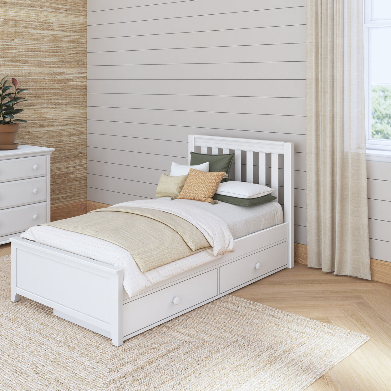 Single white bed with storage drawers in cozy modern bedroom with natural light and neutral decor.