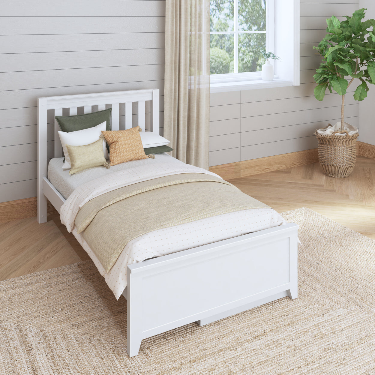 Single white bed with neutral bedding and decorative pillows in a cozy, light-filled bedroom.