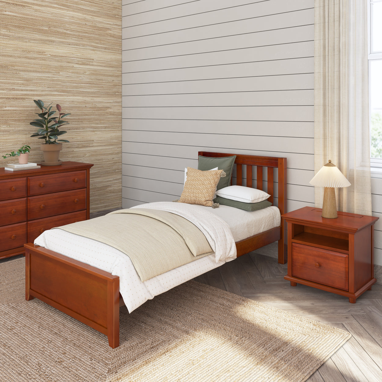 Cozy bedroom featuring a wooden bed, matching nightstand, and dresser set with a modern lamp and potted plant, ideal for rustic home decor.