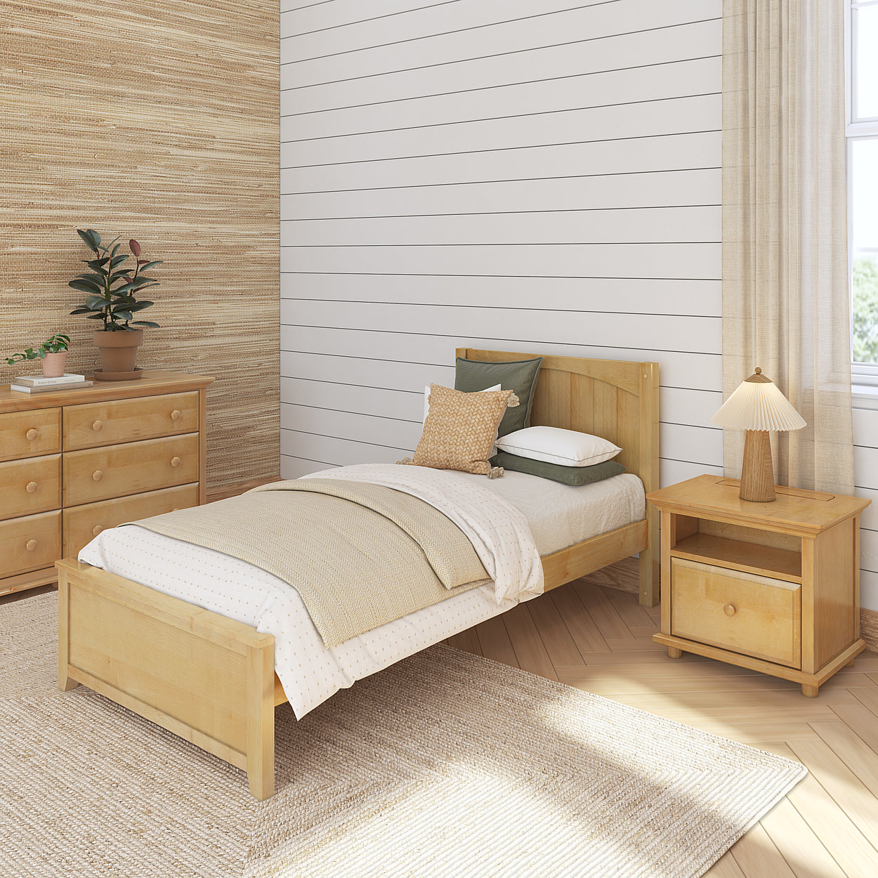 Cozy bedroom with wooden furniture, including a single bed, nightstand, and dresser, featuring neutral decor and a plant for a serene atmosphere.