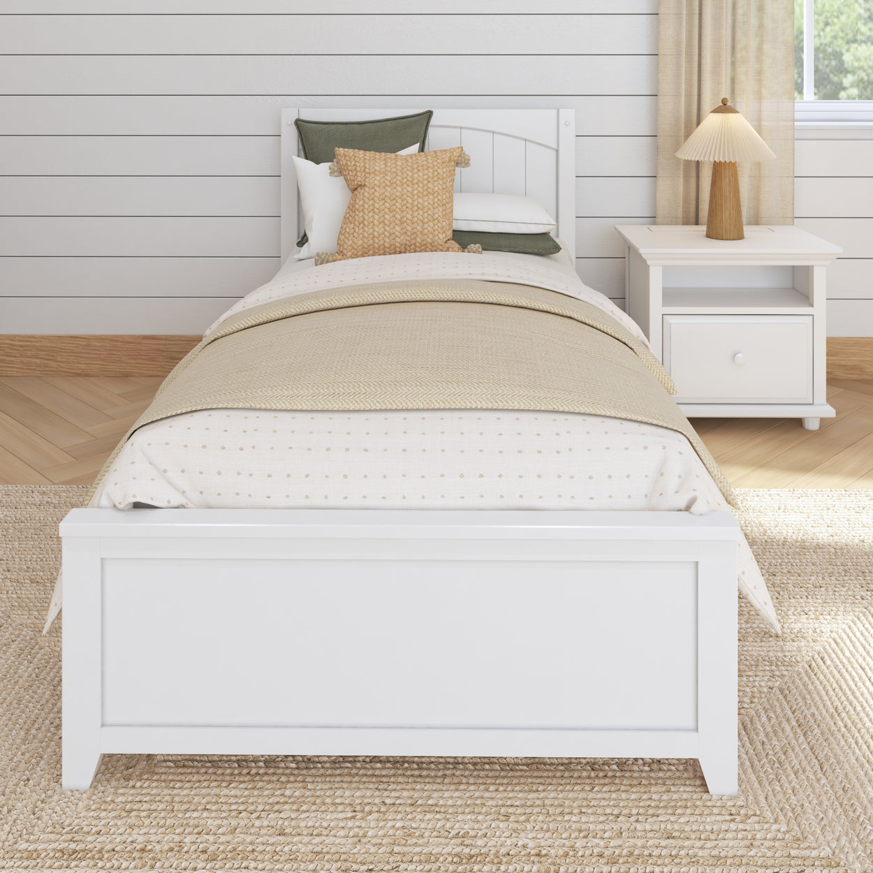 Single white bed with beige bedding in a cozy, minimalist bedroom with a matching bedside table and lamp.