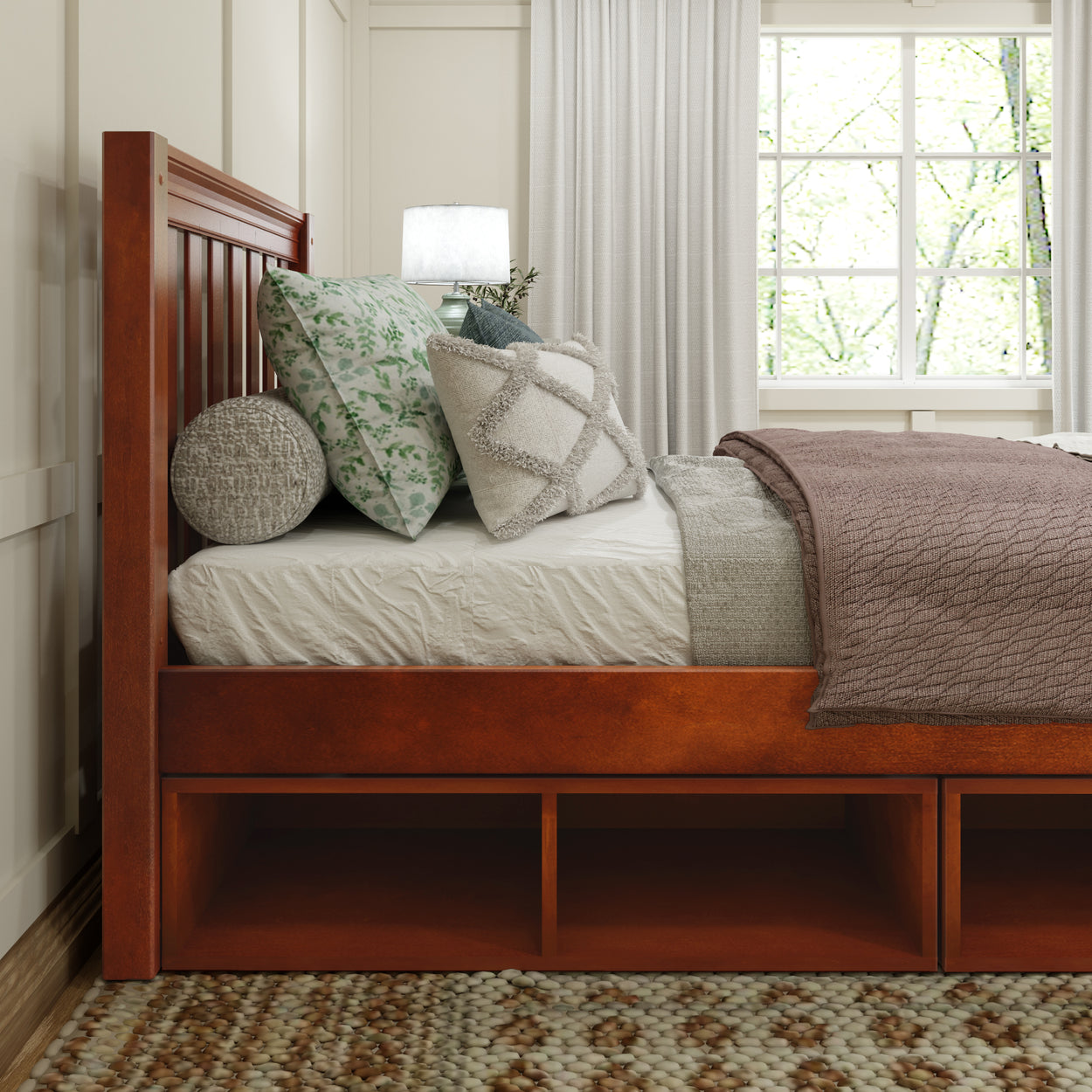 Wooden bed frame with decorative pillows and cozy blanket in a sunlit bedroom.