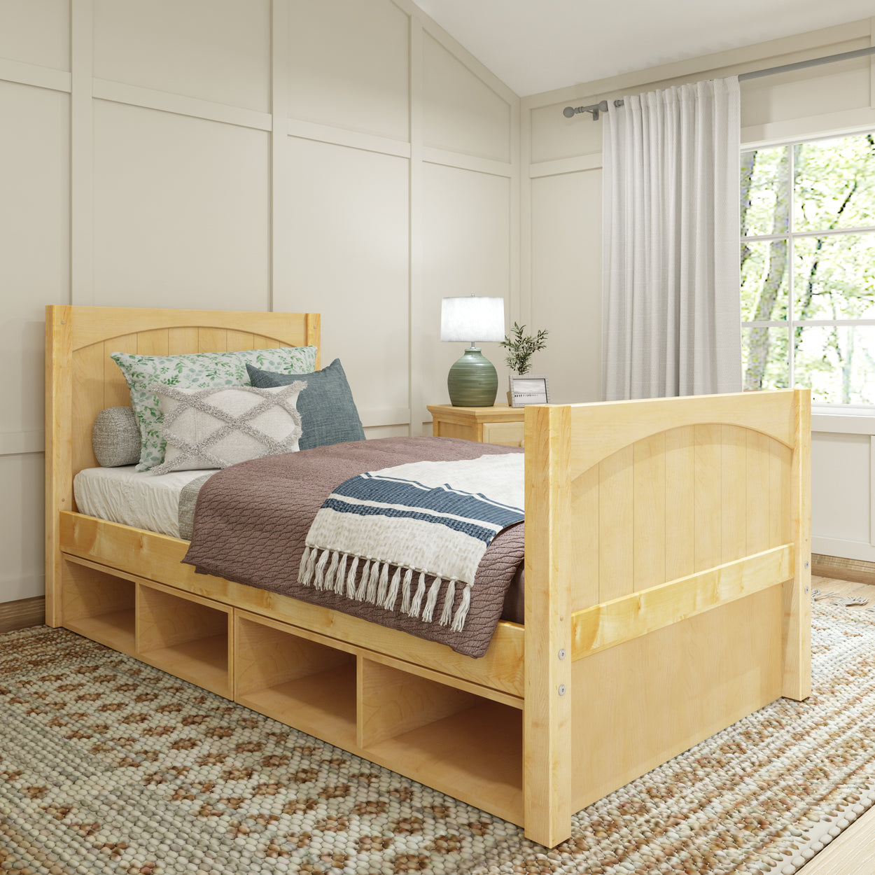 Wooden daybed with storage drawers, cozy bedding, and decorative pillows in a bright, modern bedroom.